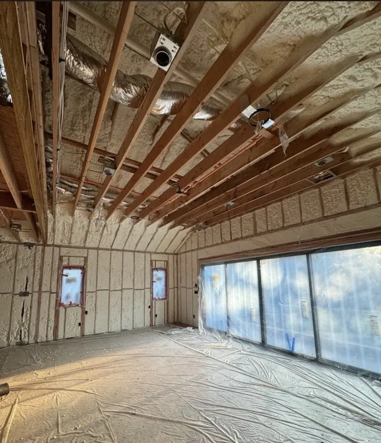 Interior walls and ceiling insulated with spray foam during new construction in Katy